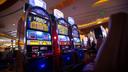 A slot machine is pictured on the floor of a casino.