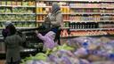 Ai'Yana Mu'Min, of West Philly, shops inside the Golden Farms supermarket with children.