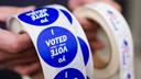 A poll worker holds voting stickers at Central Elementary School in Allentown, Lehigh County, Pennsylvania.