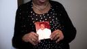 Mary Buffaloe holds a picture of her brother Raymond Caliman.