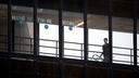 A sign that reads "HANG IN THERE WORLD" is seen in the windows of the enclosed walkway at Thomas Jefferson University Hospital in Philadelphia. State officials are asking hospitals to work together as some face a staffing crisis.