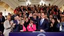 Pa. Gov. Josh Shapiro holds up Senate President Pro Tempore Kim Ward's hand as he signs the first bill of his tenure.