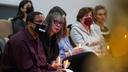 Gareth Hall, left, and his wife Fe Hall, right, look on during a vigil for their late son Christian Hall in December. Their lawsuit claims troopers used excessive force, killing Hall as he tried to surrender and after they said they would not shoot him.