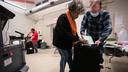 Three election workers put provisional ballots in the hopper at the 5th and 9th division of the 26th Ward after the polls closed at the polling place at Barry Recreation Center, in South Philadelphia, on Election Day.