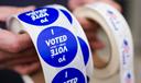 A poll worker holds voting stickers at Central Elementary School in Allentown, Lehigh County, Pennsylvania.