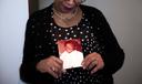 Mary Buffaloe holds a picture of her brother Raymond Caliman.