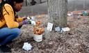 A woman cleans up the Black Lives Matter memorial at the Dr. Martin Luther King Jr. Plaza in downtown State College.