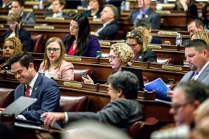 The state House on Monday passed temporary rules allowing members to vote remotely to party leaders, though those leaders will still be required to appear in person in the Capitol to formally consider legislation.