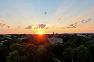 The sun shines over Old Main on Penn State’s University Park campus.