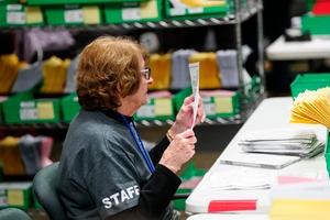 Lehigh County voter registration worker Ellen Ortt sorts mail ballots on Election Day 2023 in Allentown, Pennsylvania.