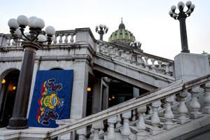 The Pennsylvania flag is seen hanging on the east side of the state Capitol building in Harrisburg.