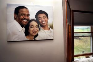 A family photo hangs on a wall in the dining room of Fe and Gareth Hall's home in Stroudsburg.