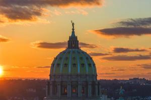 The sun rises over the state Capitol building in Harrisburg, Pennsylvania.