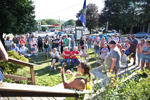 People gather on the front lawn outside of the Tioga borough building.