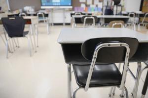 Desks are shown in a classroom.