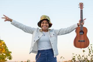 Country musician Sug Daniels poses with a guitar.