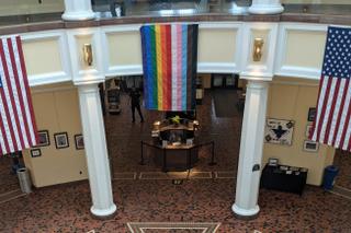 A Pride flag is currently hanging inside the Capitol’s East Wing Rotunda as part of a permitted display requested by the Commission on LGBTQ Affairs’ executive director.