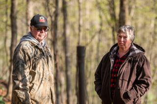 Cheryl and Joe Thomas with one of the dozens of abandoned wells on their Duke Center, Pa. property.