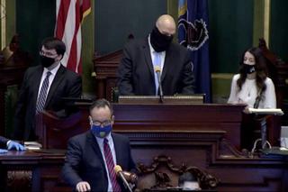 Lt. Gov. John Fetterman (center) confers with Senate Secretary Megan Martin (right), as Sen. Jake Corman (front, center), takes over the session to conduct a vote to remove Fetterman from residing over the session in Harrisburg on Tuesday, Jan. 5, 2021. Bobby Maggio, Fetterman’s chief of staff, stands to the left.