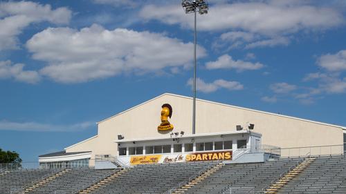 The campus of the Milton Hershey School is shown with the football stadium and the gym rising up behind